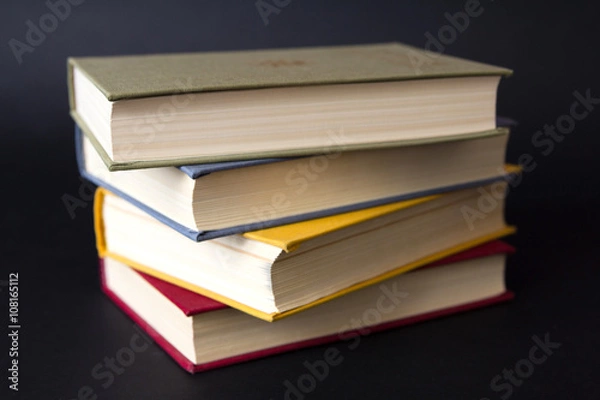 Fototapeta Stack of books on black background