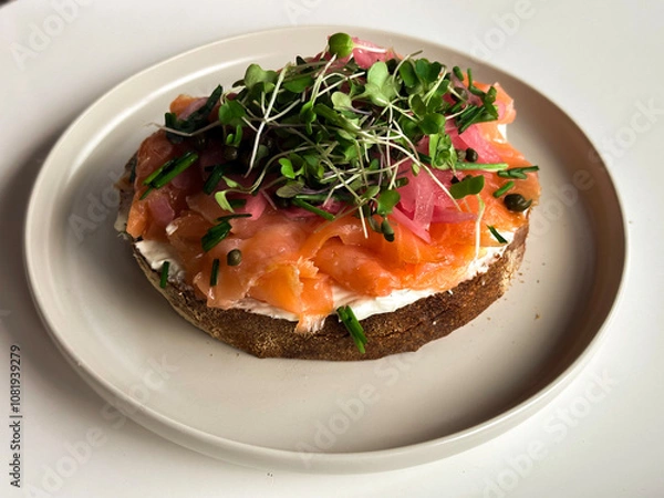 Obraz Fresh, tasty sandwich with salmon and fresh greens on a white plates 