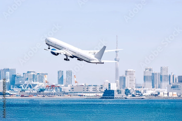 Obraz 東京の空、スカイツリーを背景に大都会を飛ぶ飛行機