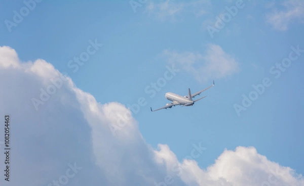Fototapeta 白い雲と青空、飛行機が飛ぶ、シンプル