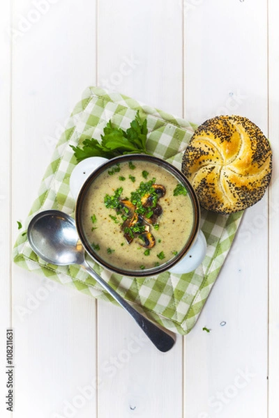 Obraz Mushroom soup with a bread roll and parsley