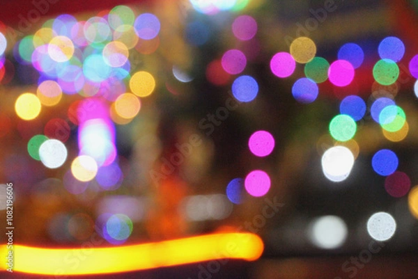 Fototapeta Colorful Defocused Bokeh Lights with Blur and Grain Texture in Night Scene