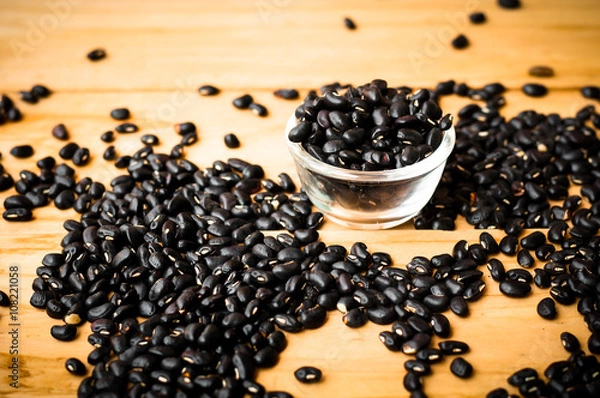Obraz black bean seed on wooden rustic background in warm tone.