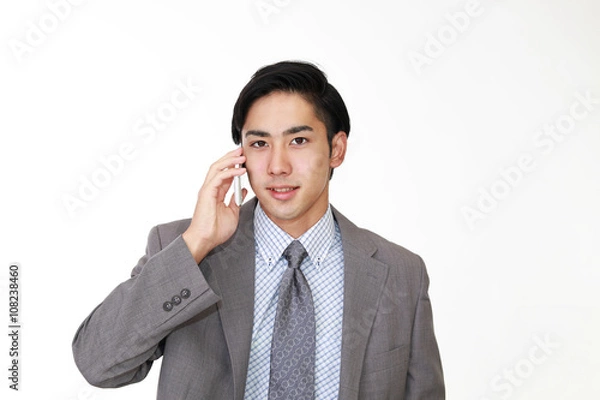 Fototapeta 通話中の笑顔のビジネスマン