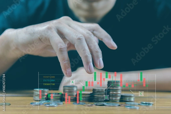 Obraz Concept of profitable investment, man use his hand to make a magic gesture to increase the return on the coin, bar chart on stacked coins.
