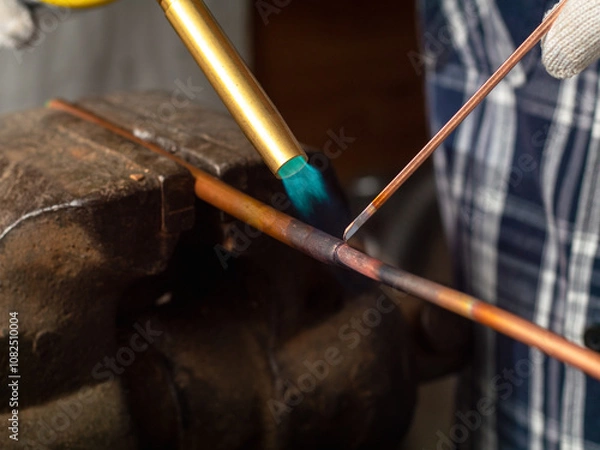 Fototapeta soldering copper pipes with a gas torch