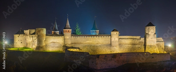 Obraz panorama of castle with towers illumination in night twilight 