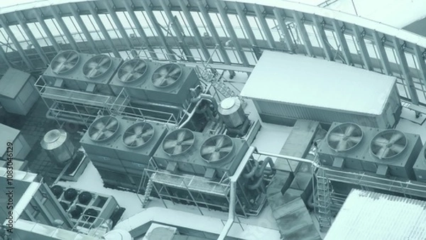 Fototapeta A lot of air conditioning unit fan spinning on roof of industrial building in American city. View from above