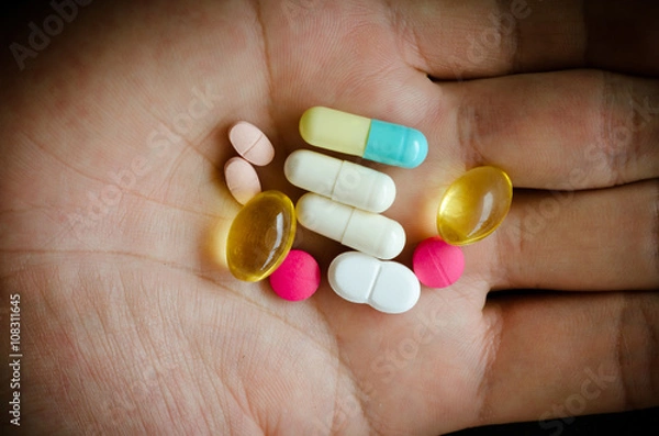 Obraz colored pills on hand