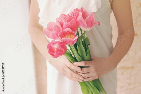 Obraz Woman holding a fresh bouquet of tulips.