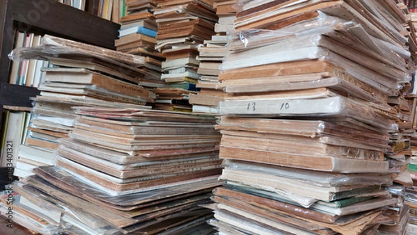 Obraz The pile of old books in a traditional bookstore gives a vintage impression and acts as a window to the world.