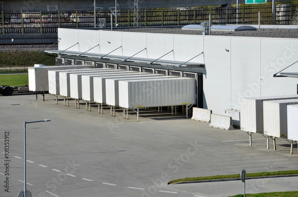 Fototapeta Cargo containers standing on gates in logistics center
