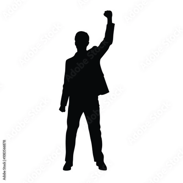 Obraz A man is standing in front of a white background. He is wearing a suit and is holding his fist up in the air