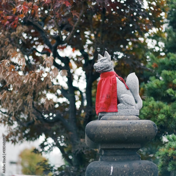 Fototapeta Fox status. A closed up details of fox status sitting in front of the Japanese shrine as shrine guardian. Japanese refers as Kitsune meaning fox. Japanese word is Bunan meaning safety.