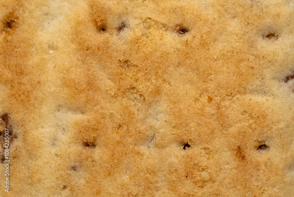 Fototapeta Cookie surface with white sugar baking sugar topping, close up of bread