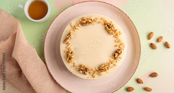 Fototapeta white chocolate cake with nuts on a plate
