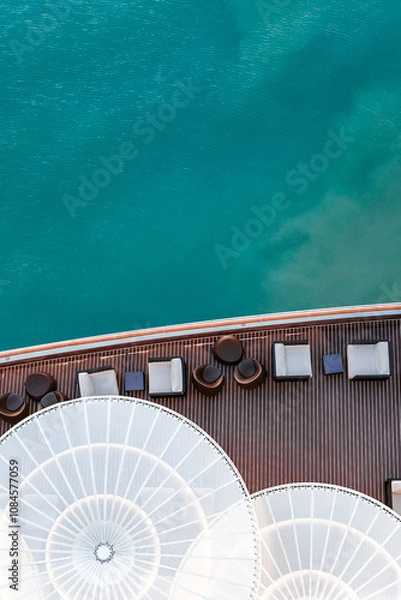Obraz Top view of sea and water of sailing ship. Lounge promenade deck on cruise liner, vertical photo