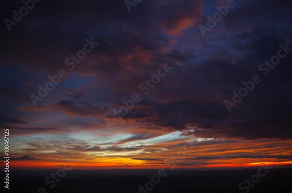 Fototapeta dark cloud and red sky before sunset