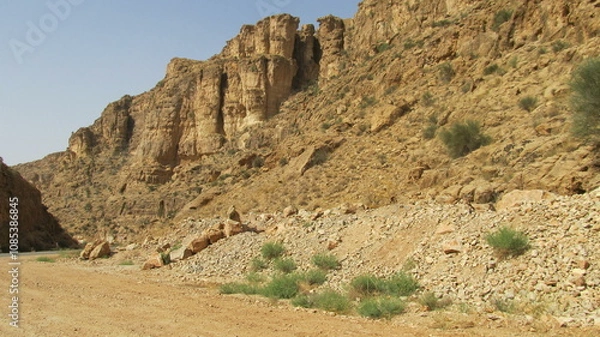 Fototapeta Stony mountains with dry terrain, capturing the harsh beauty of nature.