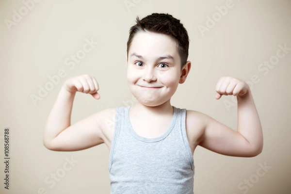 Obraz kid flexing biceps