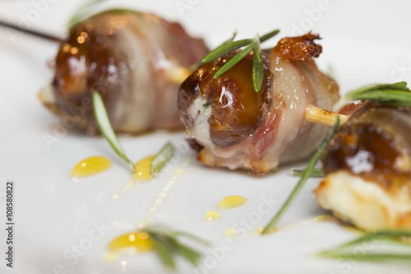 Fototapeta meat on a skewer  dates with hazelnuts  sweet sauce