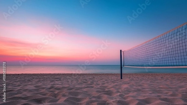 Fototapeta A serene beach scene at sunset, featuring a volleyball net and calm waves, reflecting vibrant colors in the sky.