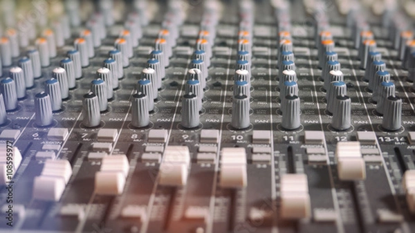 Fototapeta Mixing Board Classic Knobs. Pro audio mixing board faders and knobs, multi-track music recording equipment.