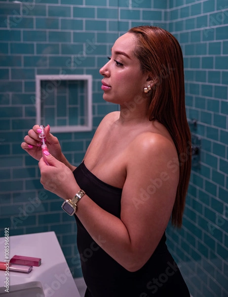 Fototapeta Beautiful latin woman putting on make up