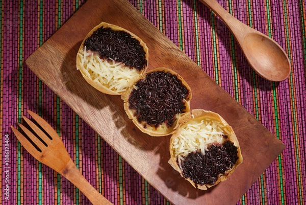 Obraz Martabak mini or terang bulan mini is Indonesian popular street food, made from flour, egg, yeast, topped with cheese or chocolate. Mini sweet martabak placed on a rainbow-colored mat