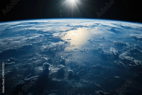 Fototapeta Earth viewed from space with the sun rising over the horizon.