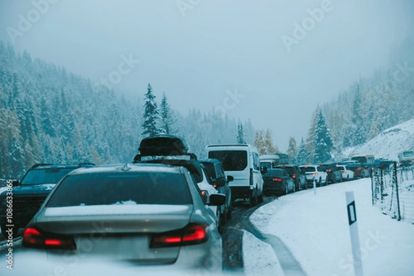 Fototapeta Traffic jam during snow day in forest mountain trail