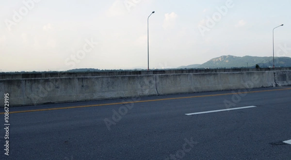 Obraz Panoramic city skyline and mountain with empty asphalt road at sunset
