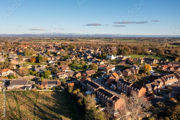 Fototapeta Aerial photo of the beautiful British town of Bedale which is a market town in the Hambleton former district of North Yorkshire in the UK showing houses and housing estates in the Autumn time