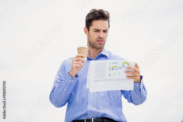 Fototapeta Businessman reading a newspaper