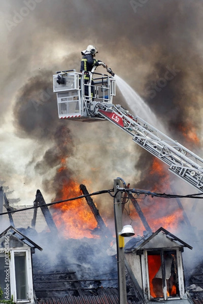 Fototapeta Fireman fighting a fire 