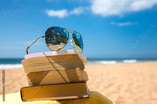Obraz Books and sunglasses on a beach