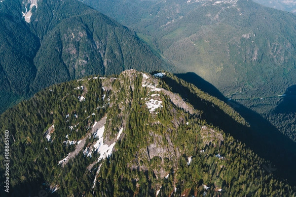 Fototapeta Green mountain peak with traces of snow on the top