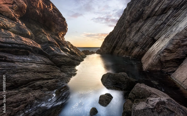 Obraz The cliff and a lagoon at the sunset