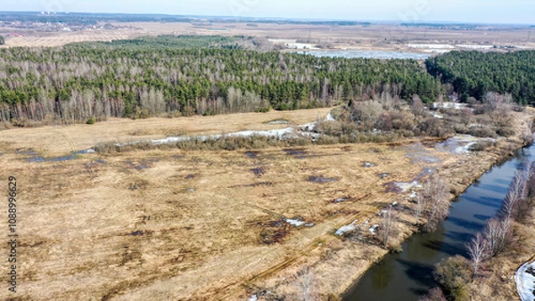 Obraz Полет на дроне вид на зимнюю реку с птичьего полета красивая природа лес после зимы