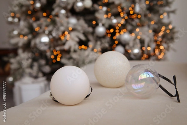 Obraz New Year's decor. Beautiful light Christmas tree balls on a blurred bokeh background. Close-up. Copyspace