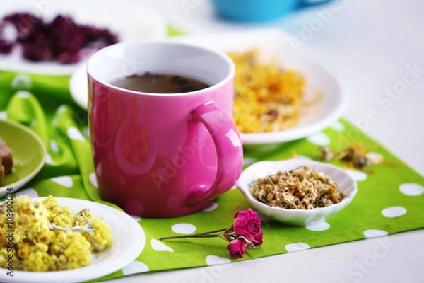 Fototapeta Cup of tea with aromatic dry tea on wooden background