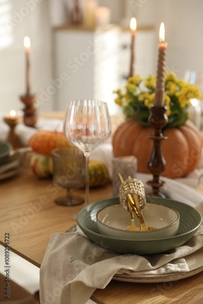 Fototapeta Stylish table setting with beautiful dishware, glasses and autumn decor in dining room