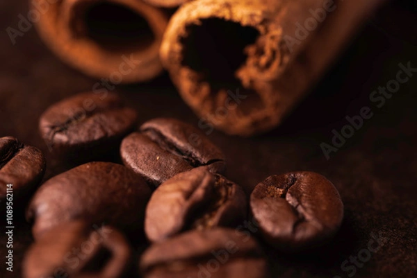 Obraz Ziarna kawy z cynamonem na brązowym tle