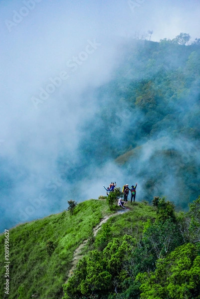 Obraz Adventurous hiking journey mountain peak outdoor activity foggy environment group perspective team spirit and nature exploration