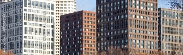 Fototapeta Large beautiful modern buildings are designed with lots of windows to showcase urban architectural design and public life.