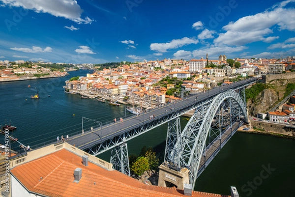 Fototapeta View of Porto city and Douro river with moored sailing ship and Dom Luis bridge I from famous tourist viewpoint Miradouro da Serra do Pilar on sunset. Porto, Vila Nova de Gaia, Portugal