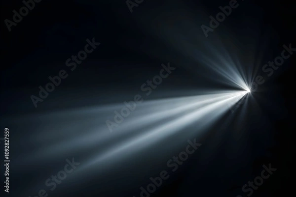 Fototapeta Light beams piercing through darkness create enchanting visuals