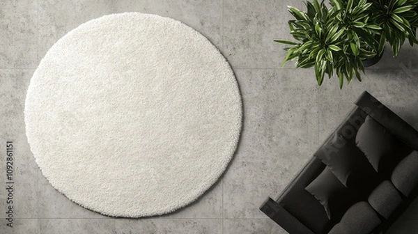 Obraz Modern Living Room with Circular White Rug – Minimalist Top View, Textured Carpet, Gray Tile Floor, Black Sofa, Green Plant, Contemporary Interior Design Aesthetic