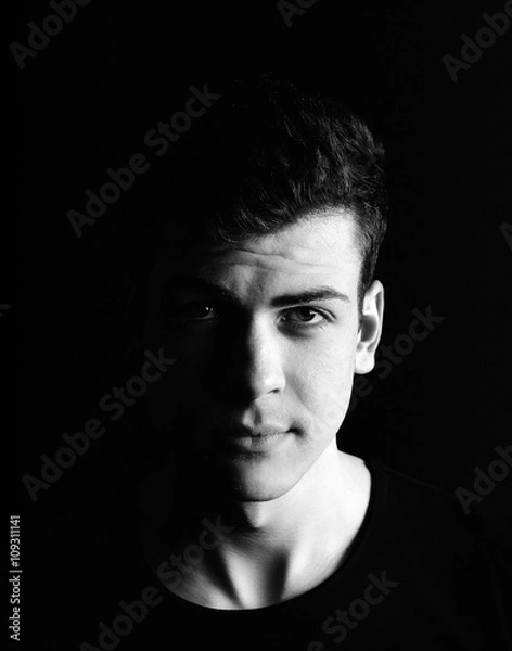 Obraz half-face young man portrait in low-key
