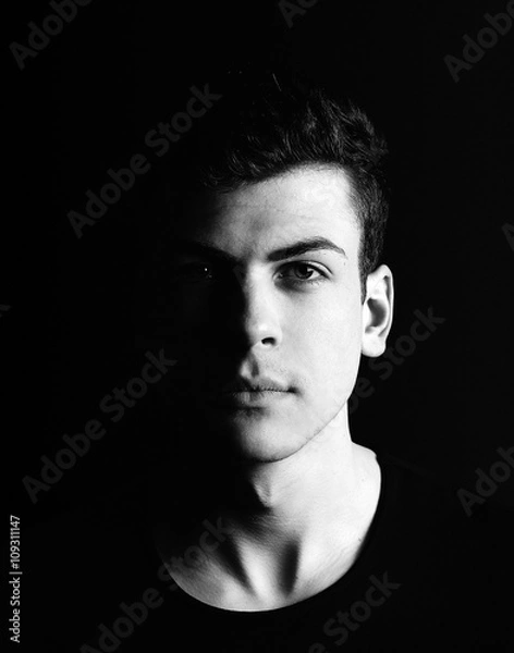 Obraz half-face young man portrait in low-key
